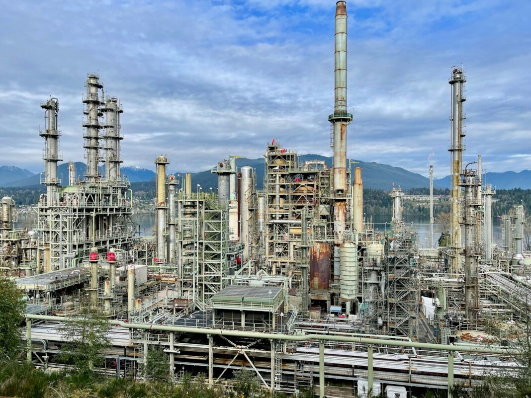A large industrial area with a lot of tall buildings petroleum refinery